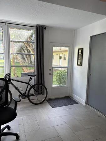 a view of a room with gym equipment and a window
