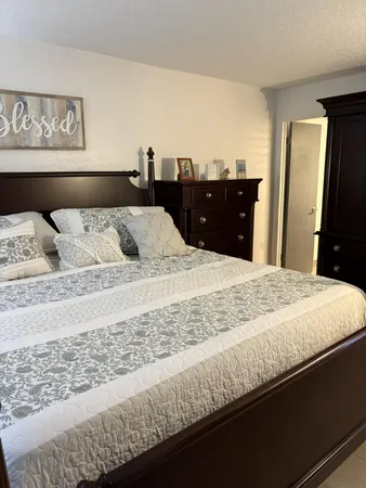 a bed sitting in a bedroom and dresser