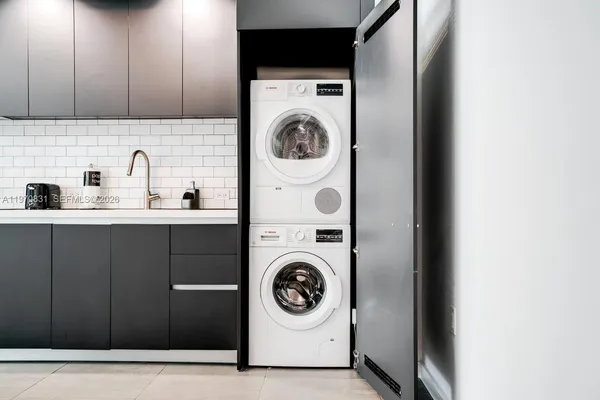 a utility room with sink washer and dryer
