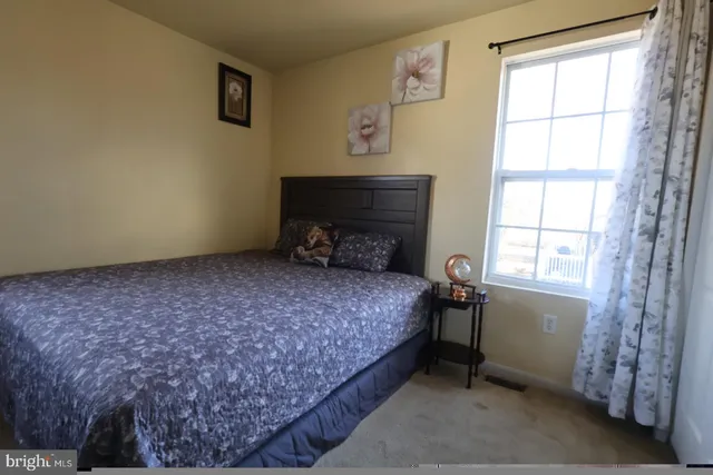 a bed sitting in a room next to a window