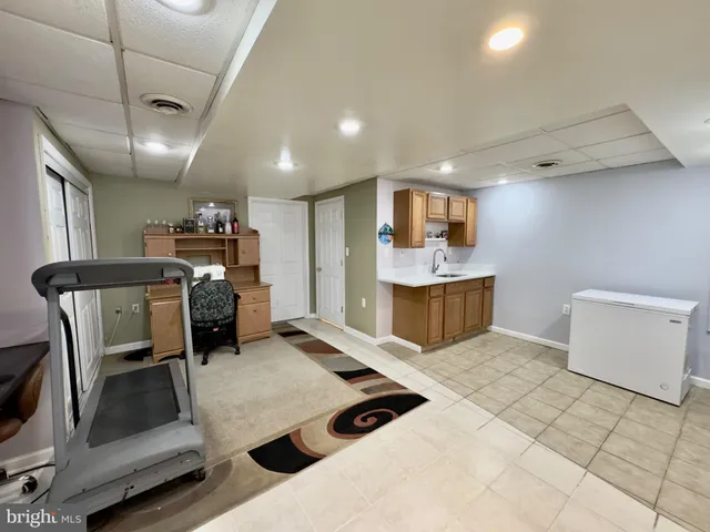a kitchen with refrigerator and chairs