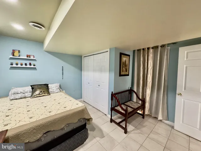 a bedroom with a bed and a dresser in it