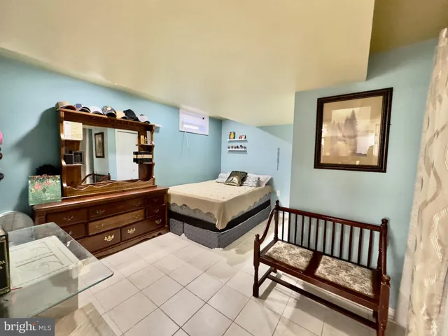 a bedroom with furniture and wooden floor