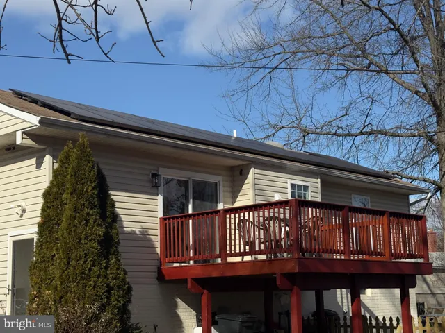 a view of a house with a yard covered in snow