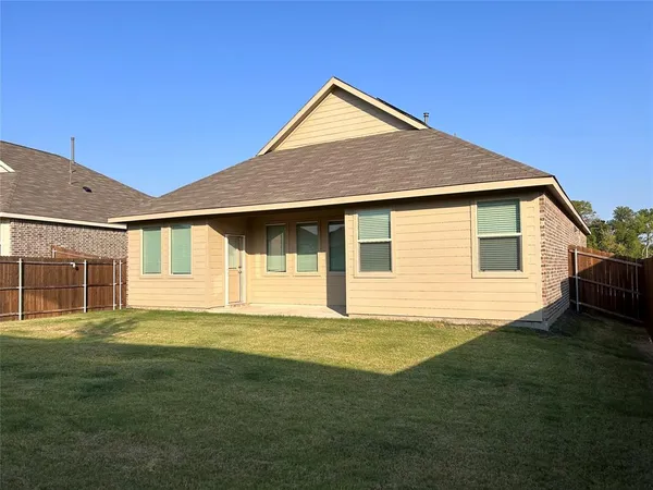 a front view of a house with a garden and yard