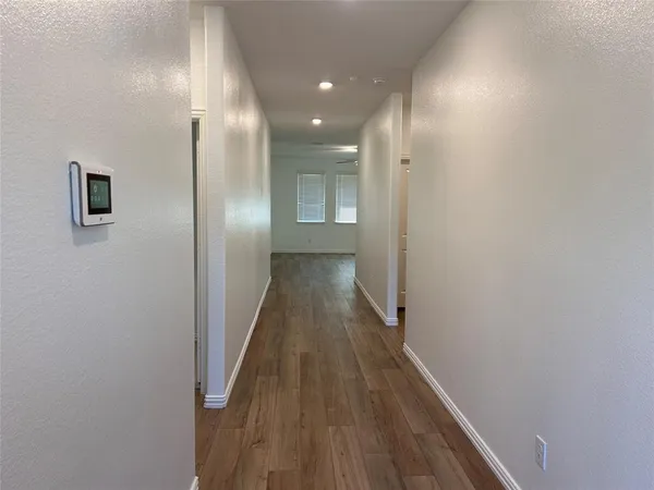 a view of hallway with wooden floor