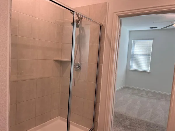 a bathroom with a glass door shower