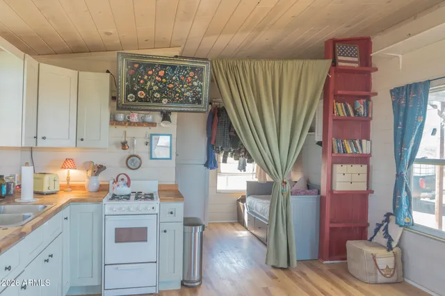 a kitchen with stainless steel appliances granite countertop a stove a sink and a cabinets