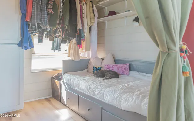 a bedroom with a bed and a window