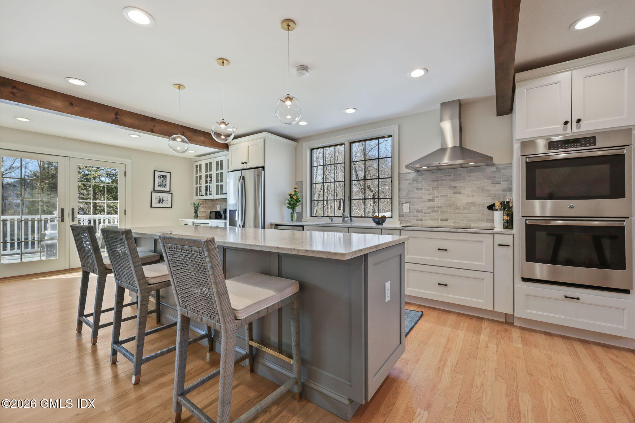97 Davenport Ridge Lane Stamford, CT 06903 - Photo 11 of 31 a kitchen with stainless steel appliances granite countertop a stove a sink dishwasher a dining table and chairs with wooden floor