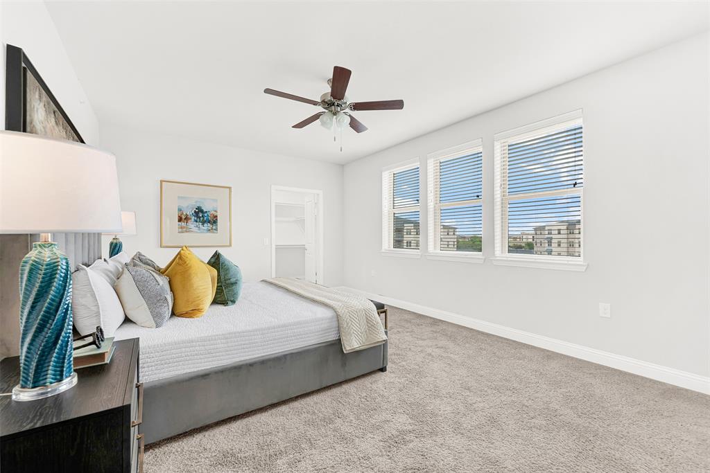 651 Watters Road, Unit 7406 Allen, TX 75013 - Photo 23 of 37 Windows in the primary bedroom overlook the garden area