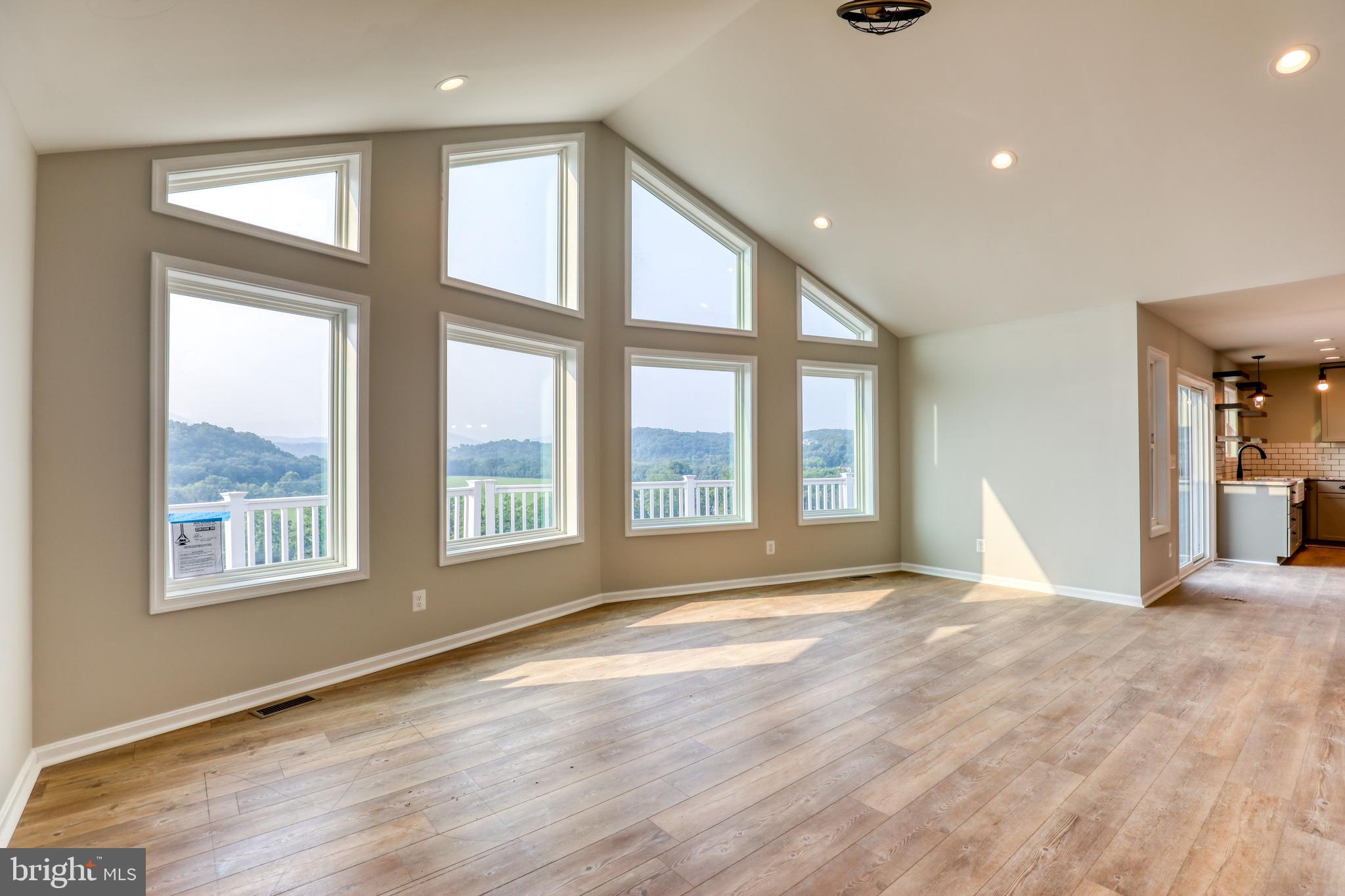 0 Gooney Manor Loop Bentonville, VA 22610 - Photo 13 of 17 a view of an empty room with a window and wooden floor