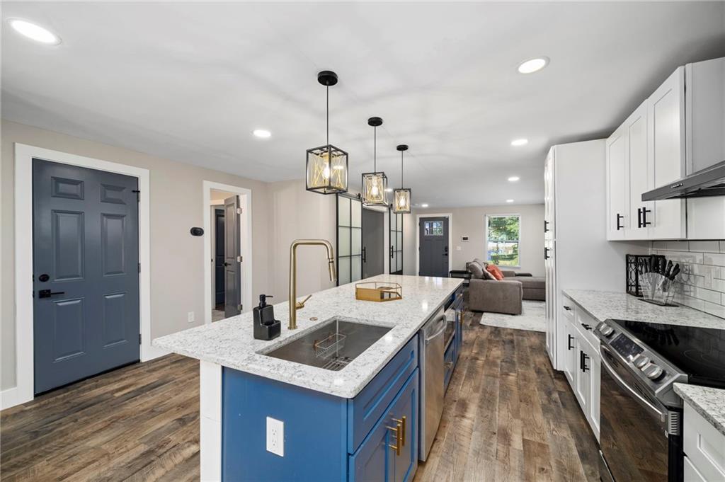 298 Roy Street Southwest Atlanta, GA 30310 - Photo 13 of 50 a kitchen with stainless steel appliances a sink stove and refrigerator