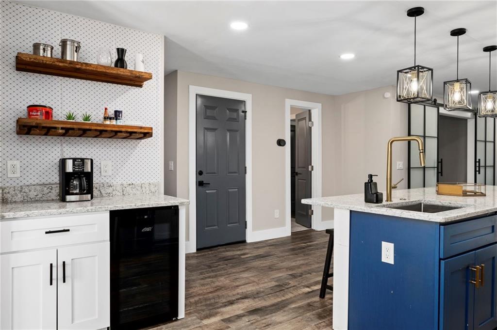 298 Roy Street Southwest Atlanta, GA 30310 - Photo 19 of 50 a kitchen with kitchen island a sink and wooden floor