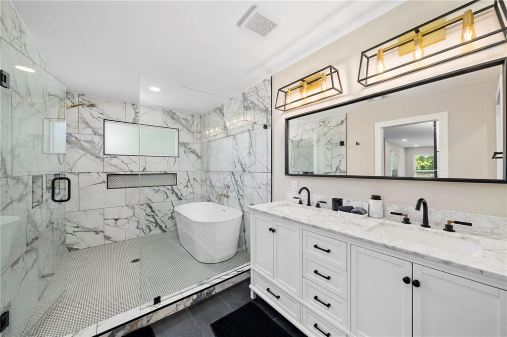 298 Roy Street Southwest Atlanta, GA 30310 - Photo 29 of 50 a bathroom with a double vanity sink mirror and shower