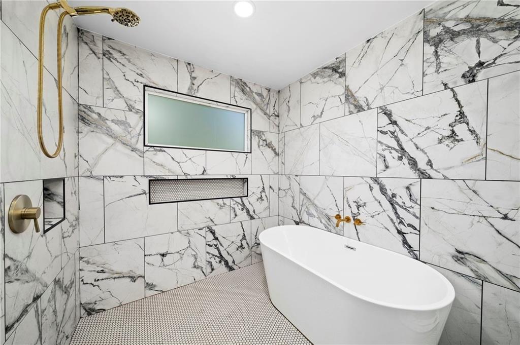 298 Roy Street Southwest Atlanta, GA 30310 - Photo 30 of 50 a bathroom with a bathtub and shower