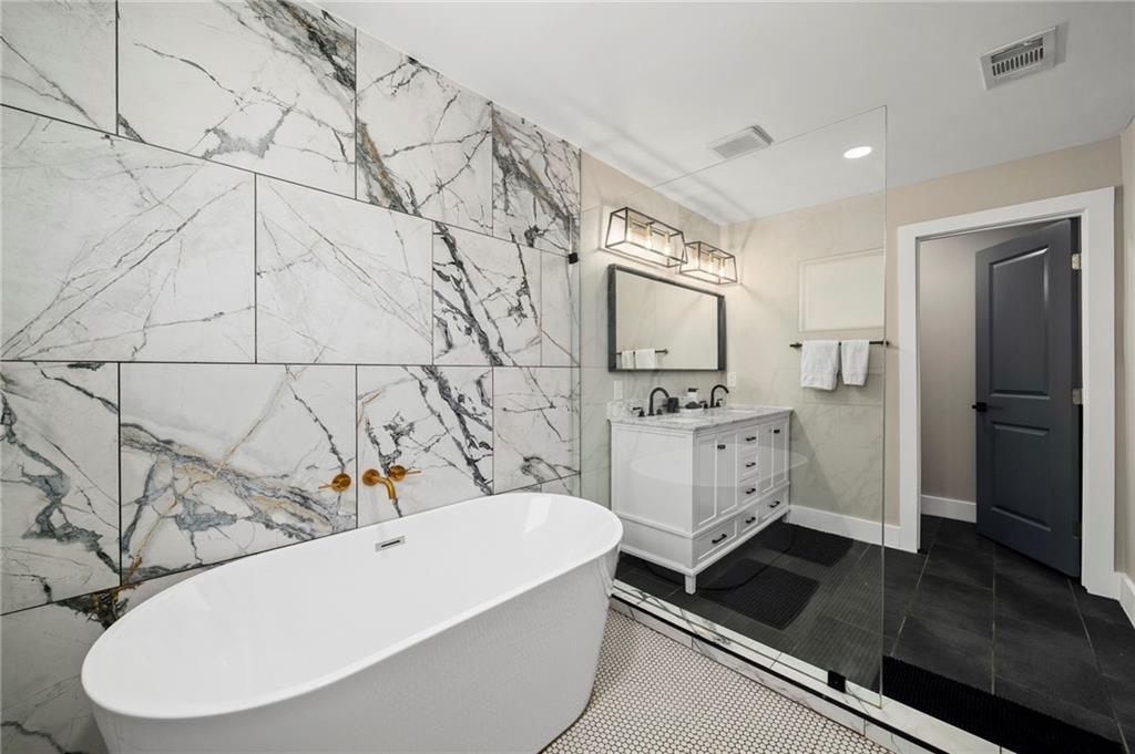 298 Roy Street Southwest Atlanta, GA 30310 - Photo 31 of 50 a bathroom with a sink a mirror and a bathtub