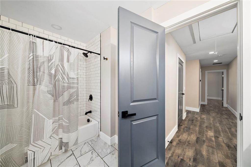 298 Roy Street Southwest Atlanta, GA 30310 - Photo 39 of 50 a bathroom with a shower and a sink