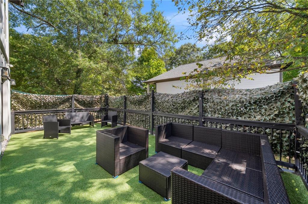 298 Roy Street Southwest Atlanta, GA 30310 - Photo 43 of 50 a view of a backyard with couches plants and large trees