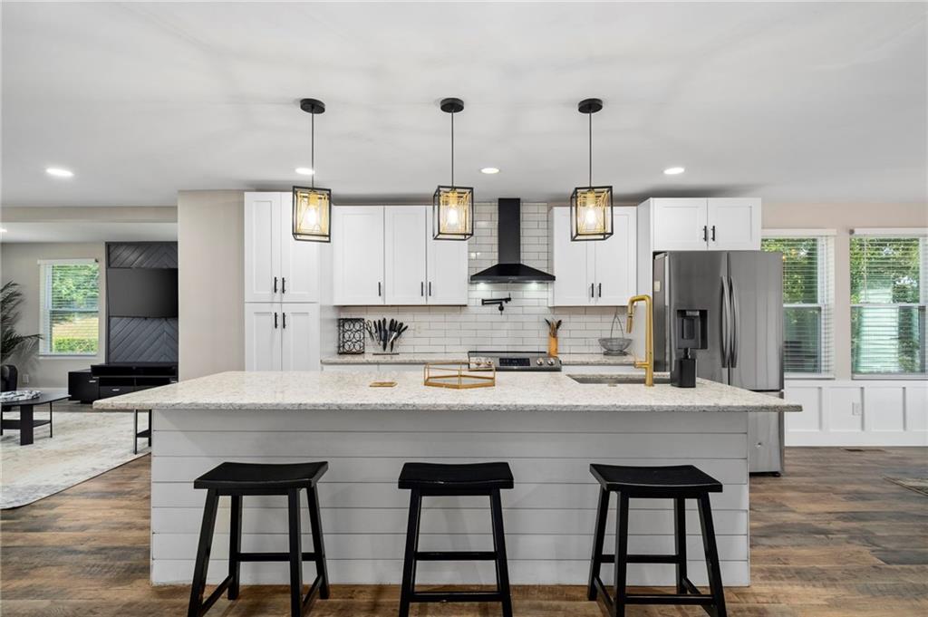 298 Roy Street Southwest Atlanta, GA 30310 - Photo 10 of 50 a large kitchen with granite countertop a stove a sink a refrigerator and a dining table