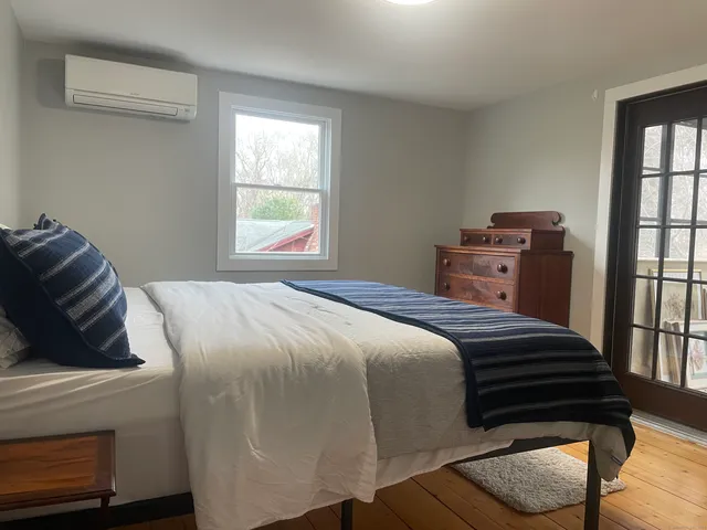 a bedroom with a bed and window