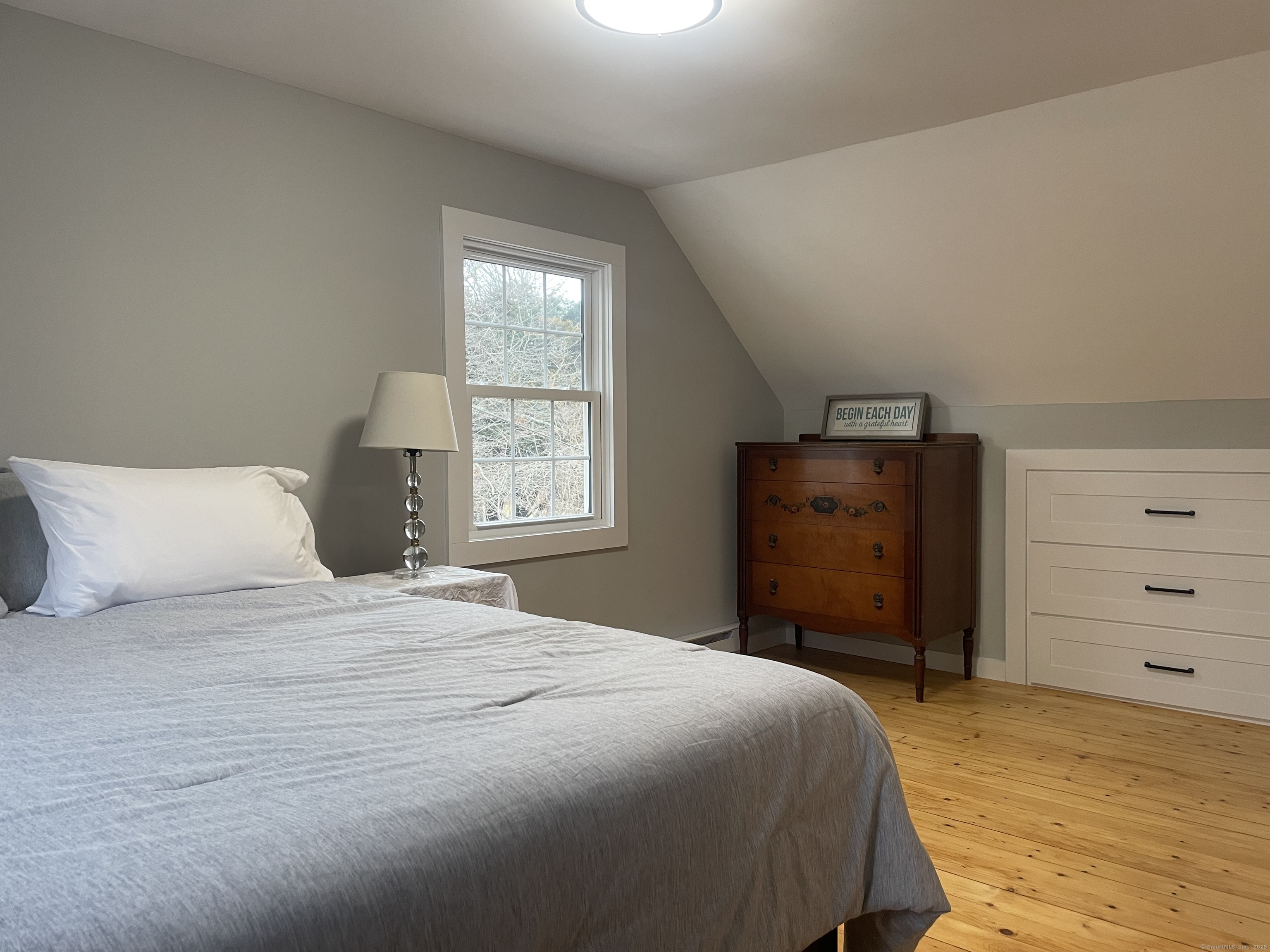 12 Little Gull Lane Groton, CT 06355 - Photo 18 of 25 a bedroom with a bed and a window