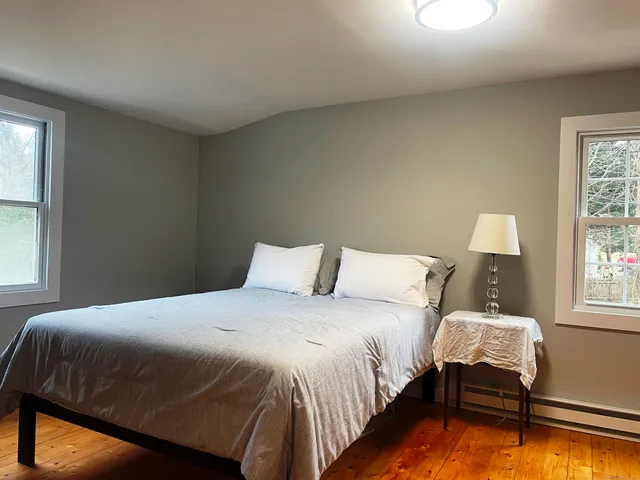 a bedroom with a bed and a window