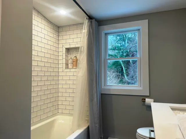 a bathroom with a bathtub and shower