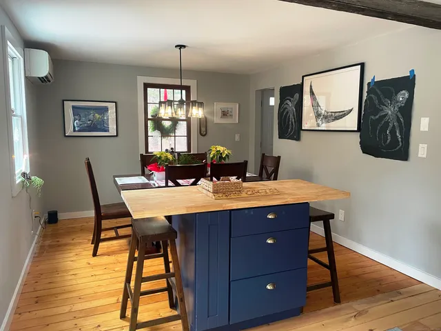 a view of a dining room with furniture wooden floor and chandelier