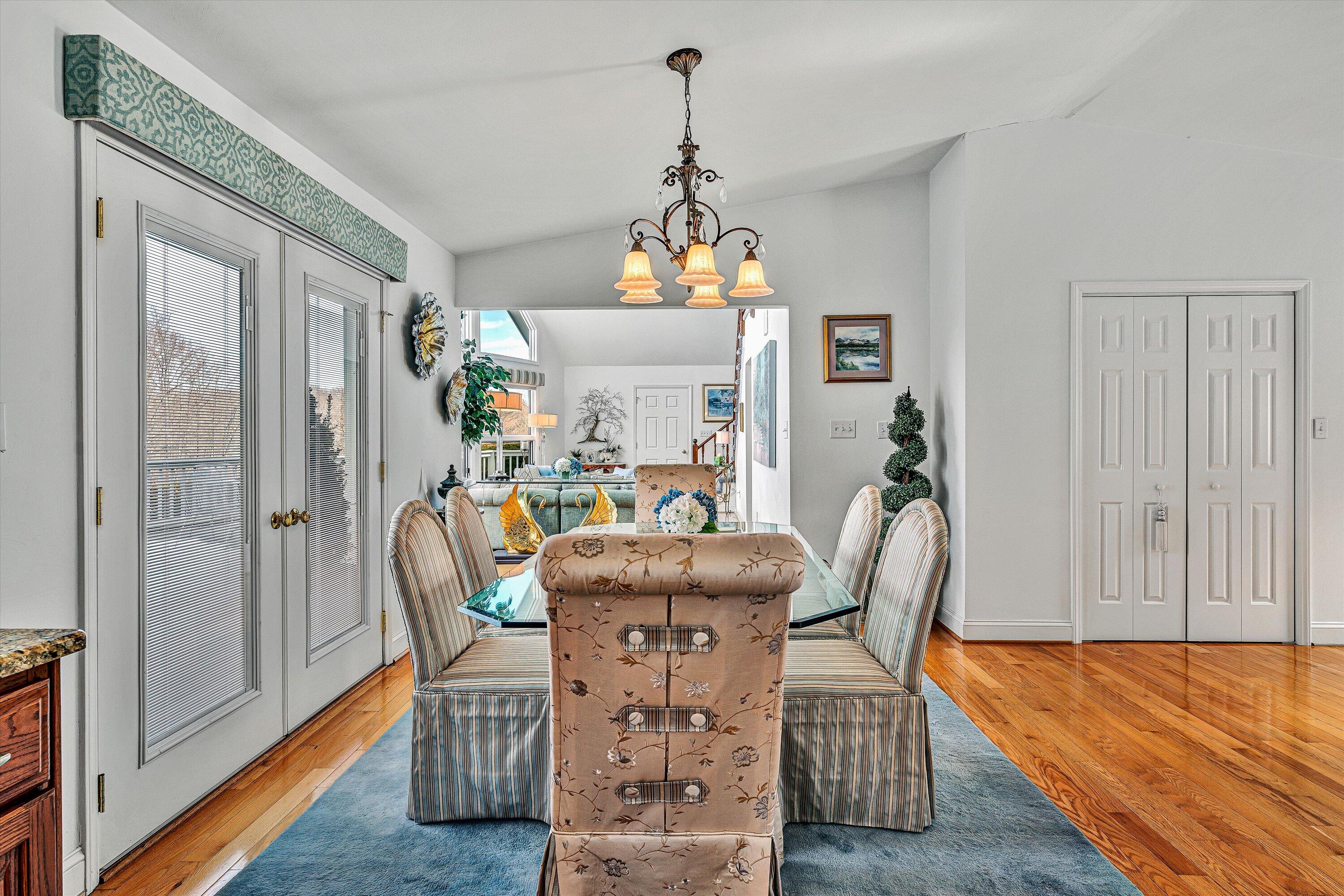 540 Cedar Ridge Road Union Hall, VA 24176 - Photo 11 of 46 a dining room with furniture a chandelier and wooden floor