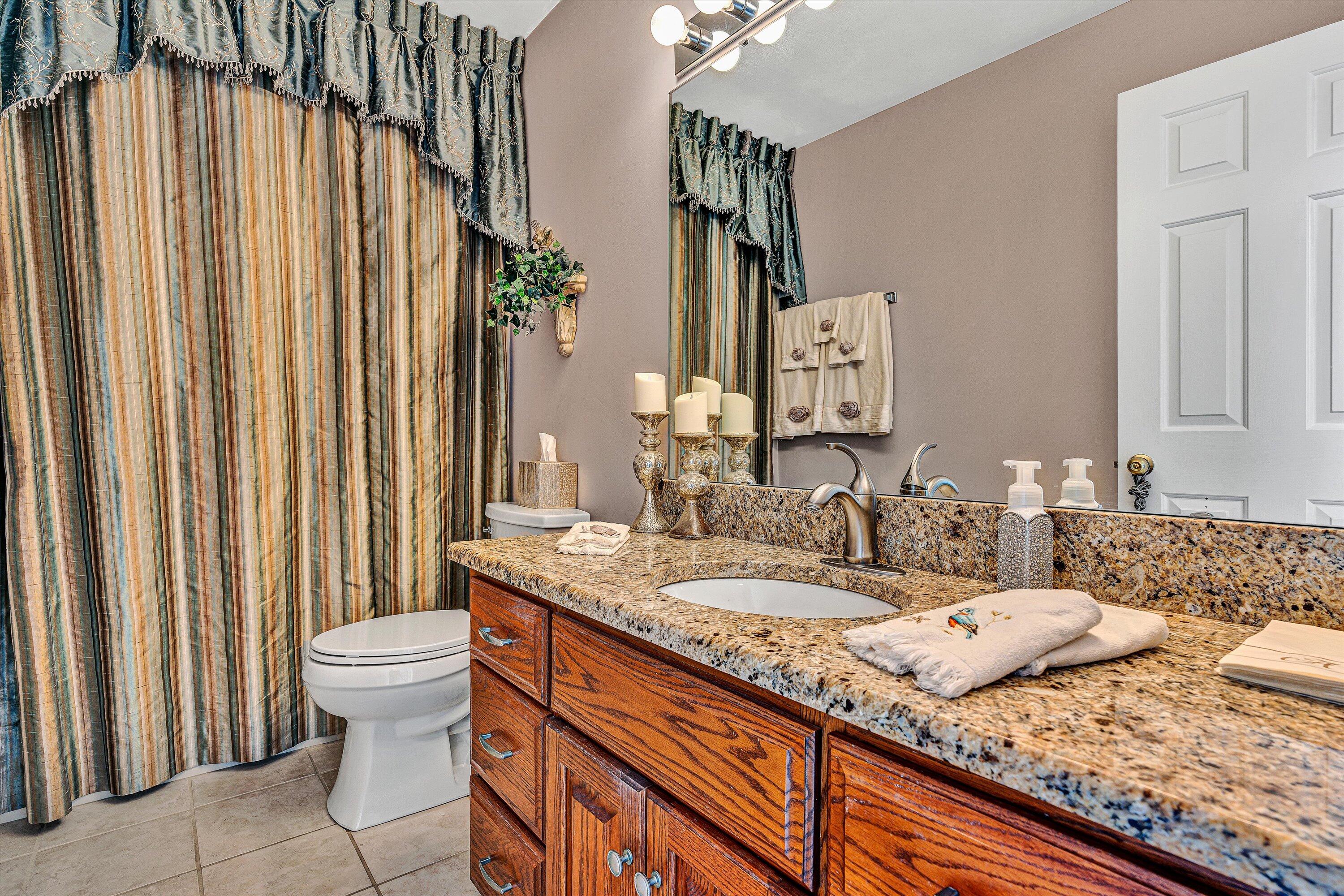 540 Cedar Ridge Road Union Hall, VA 24176 - Photo 21 of 46 a bathroom with a granite countertop sink and a mirror
