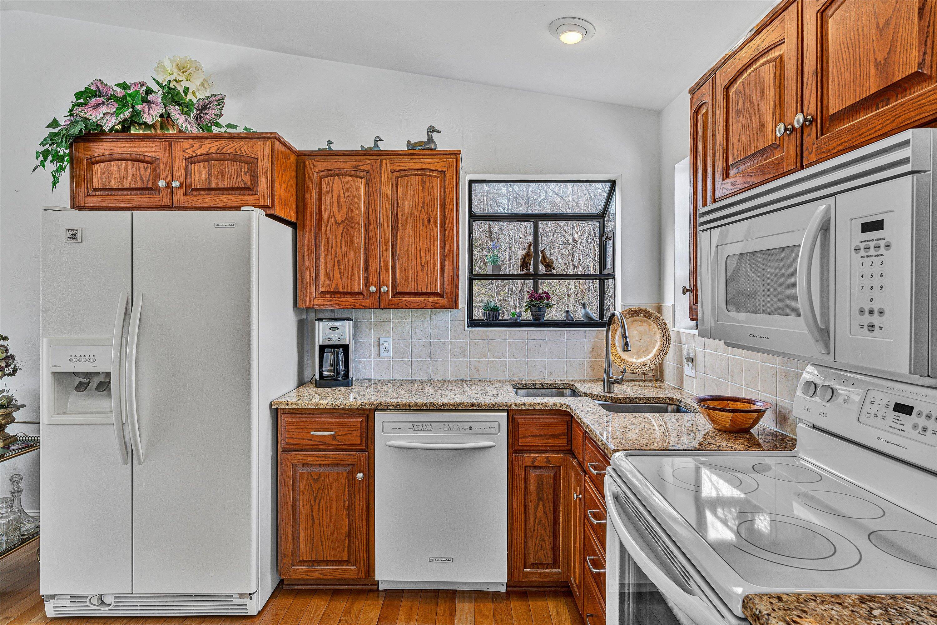 540 Cedar Ridge Road Union Hall, VA 24176 - Photo 10 of 46 a kitchen with stainless steel appliances granite countertop a refrigerator a stove and a sink with wooden cabinets