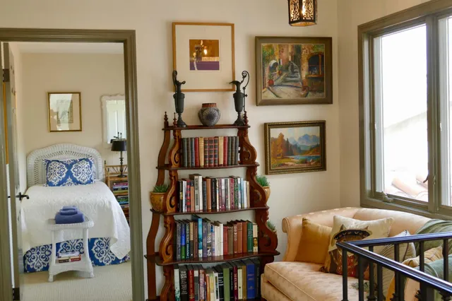 a living room with furniture and a book shelf
