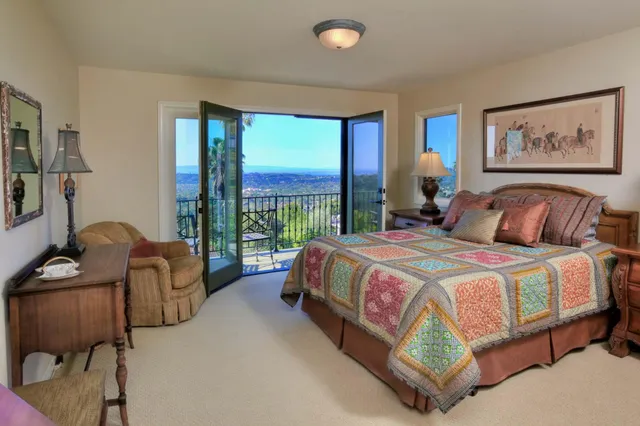 a bedroom with bed and glass window
