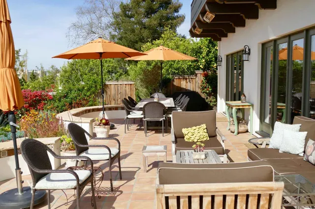 a view of a patio with furniture and wooden floor