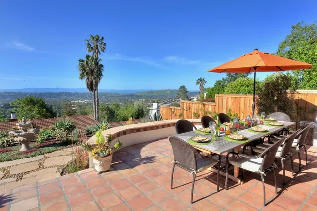 a view of an outdoor space with furniture and umbrella
