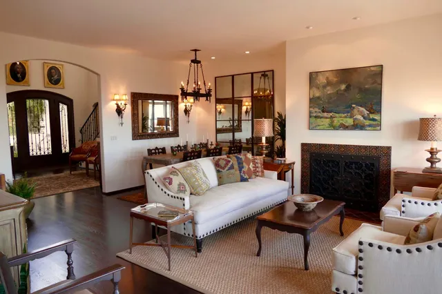 a living room with furniture a flat screen tv and a fireplace