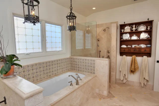 a bathroom with a bathtub a shower a and sink