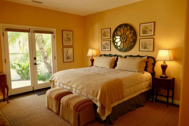 a bedroom with a bed and a lamp next to a window