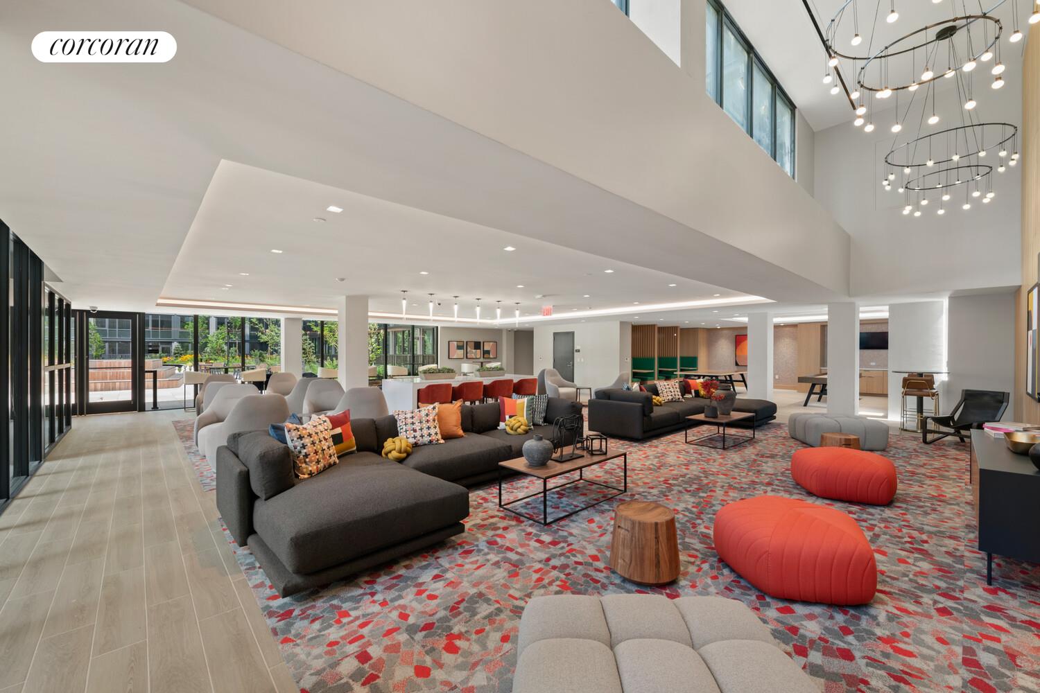 166-20 90th Avenue, Unit 436 Queens, NY 11432 - Photo 11 of 15 a living room with furniture a rug potted plant and a large window