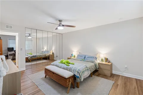 a bedroom with a bed couch and a window