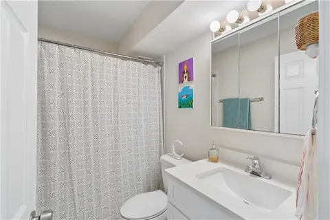 a bathroom with a sink toilet and shower
