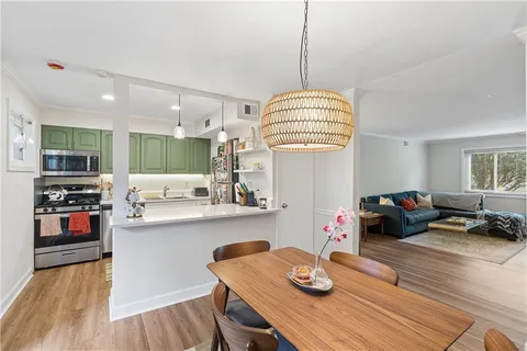 a living room with kitchen island furniture and a wooden floor