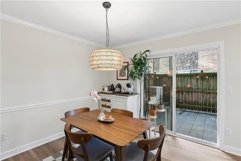 a view of a dining room with a table and chairs