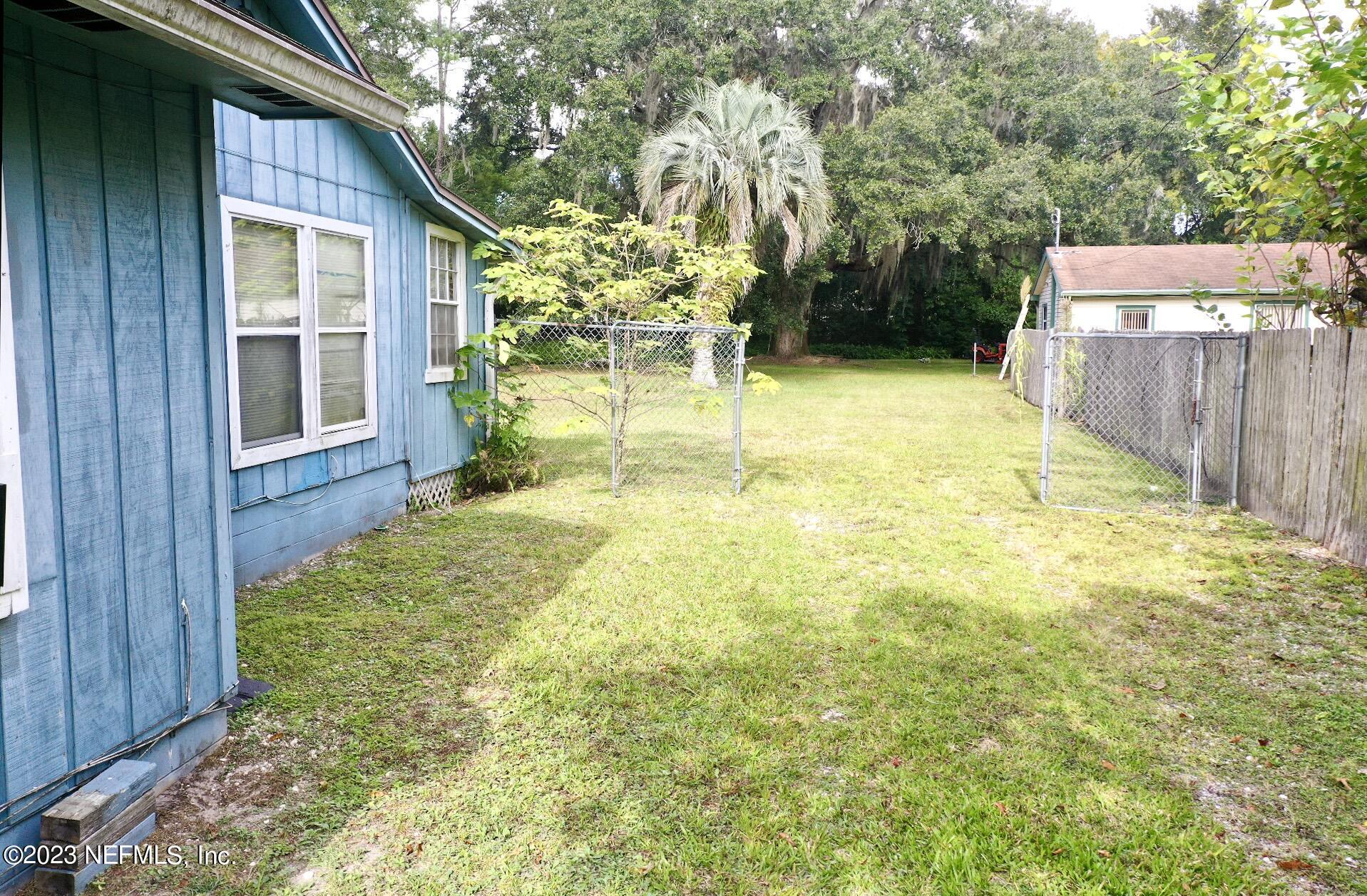 2158 Parental Home Road Jacksonville, FL 32216 - Photo 13 of 18 a view of a backyard with a small cabin
