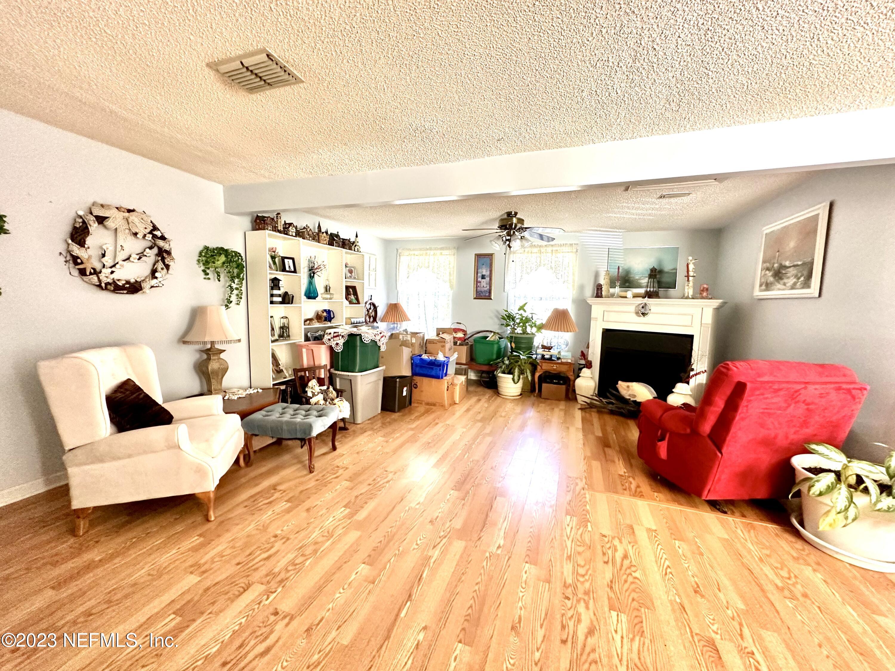 2158 Parental Home Road Jacksonville, FL 32216 - Photo 3 of 18 a living room with furniture and a fireplace