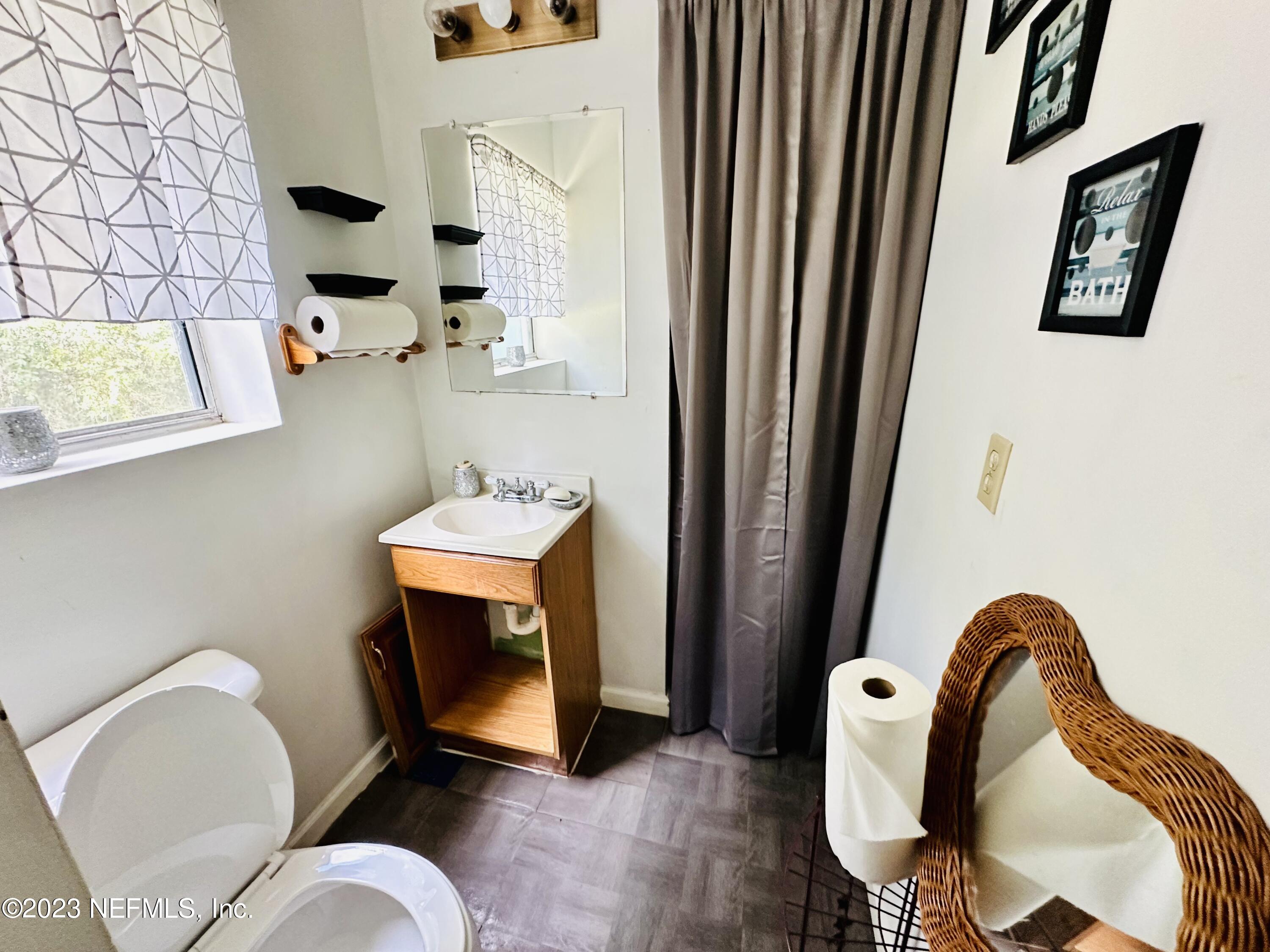 2158 Parental Home Road Jacksonville, FL 32216 - Photo 8 of 18 a bathroom with a sink mirror and toilet