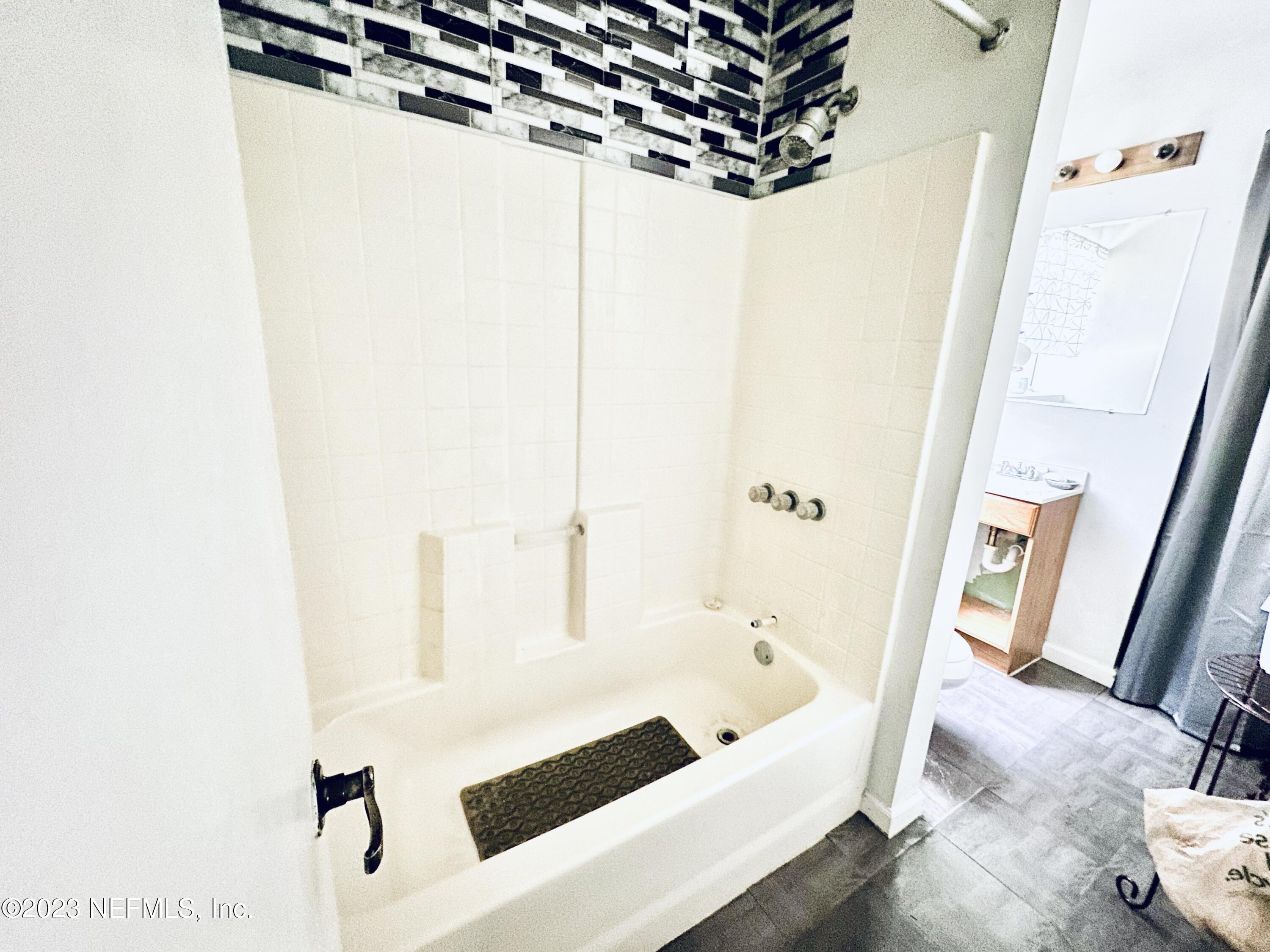 2158 Parental Home Road Jacksonville, FL 32216 - Photo 9 of 18 a bathroom with a bathtub and a shower