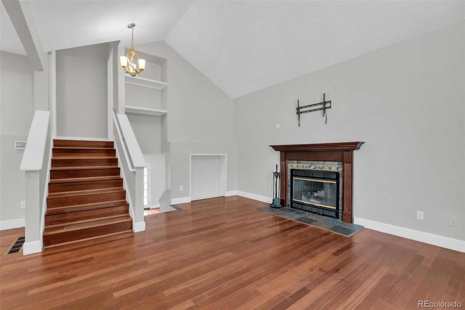 1227 Coronado Road Elizabeth, CO 80107 - Photo 11 of 45 a view of a livingroom with wooden floor and a fireplace