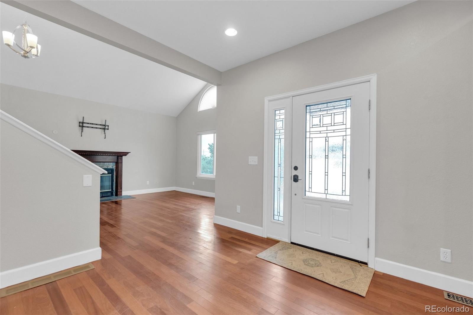 1227 Coronado Road Elizabeth, CO 80107 - Photo 13 of 45 a view of empty room with wooden floor and fan